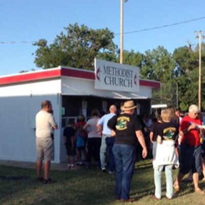 Community enjoying the county fair stand